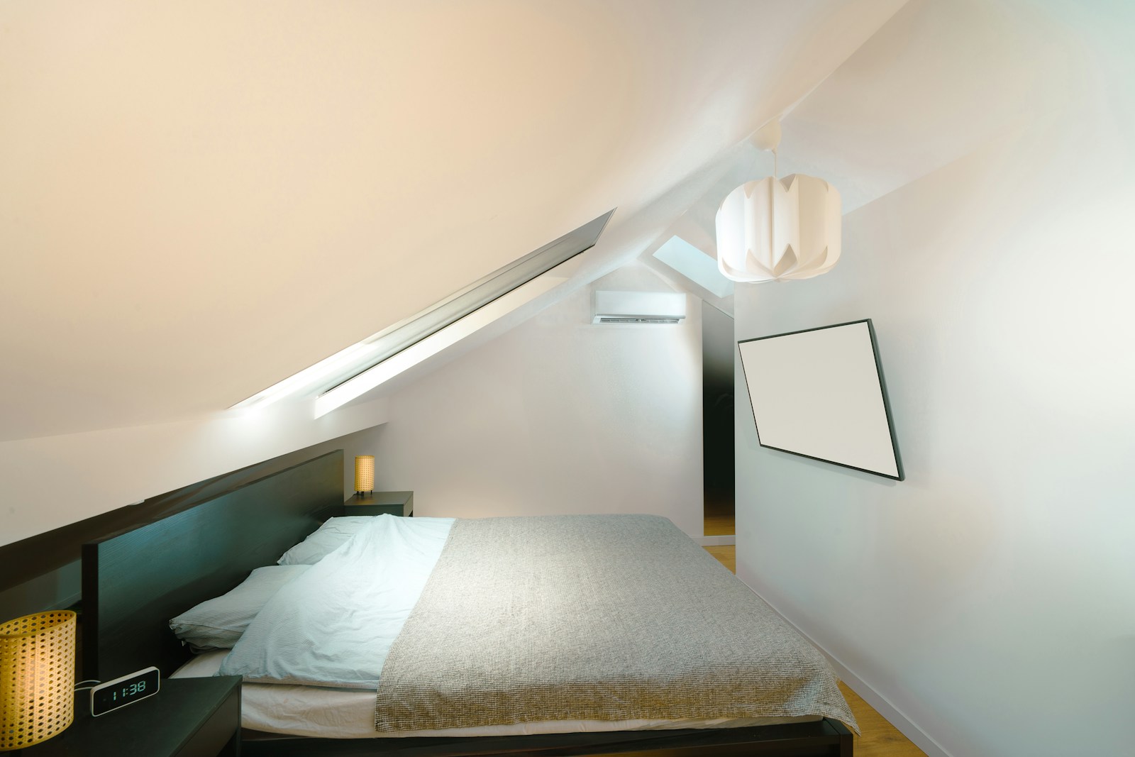 A bed in a room with a slanted ceiling