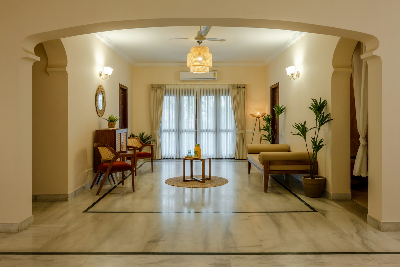 a living room filled with furniture and a ceiling fan