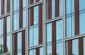 a tall building with lots of windows next to a clock