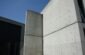a building made of concrete with a blue sky in the background