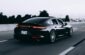 running black Porsche sedan