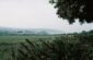 a view of a field with mountains in the distance