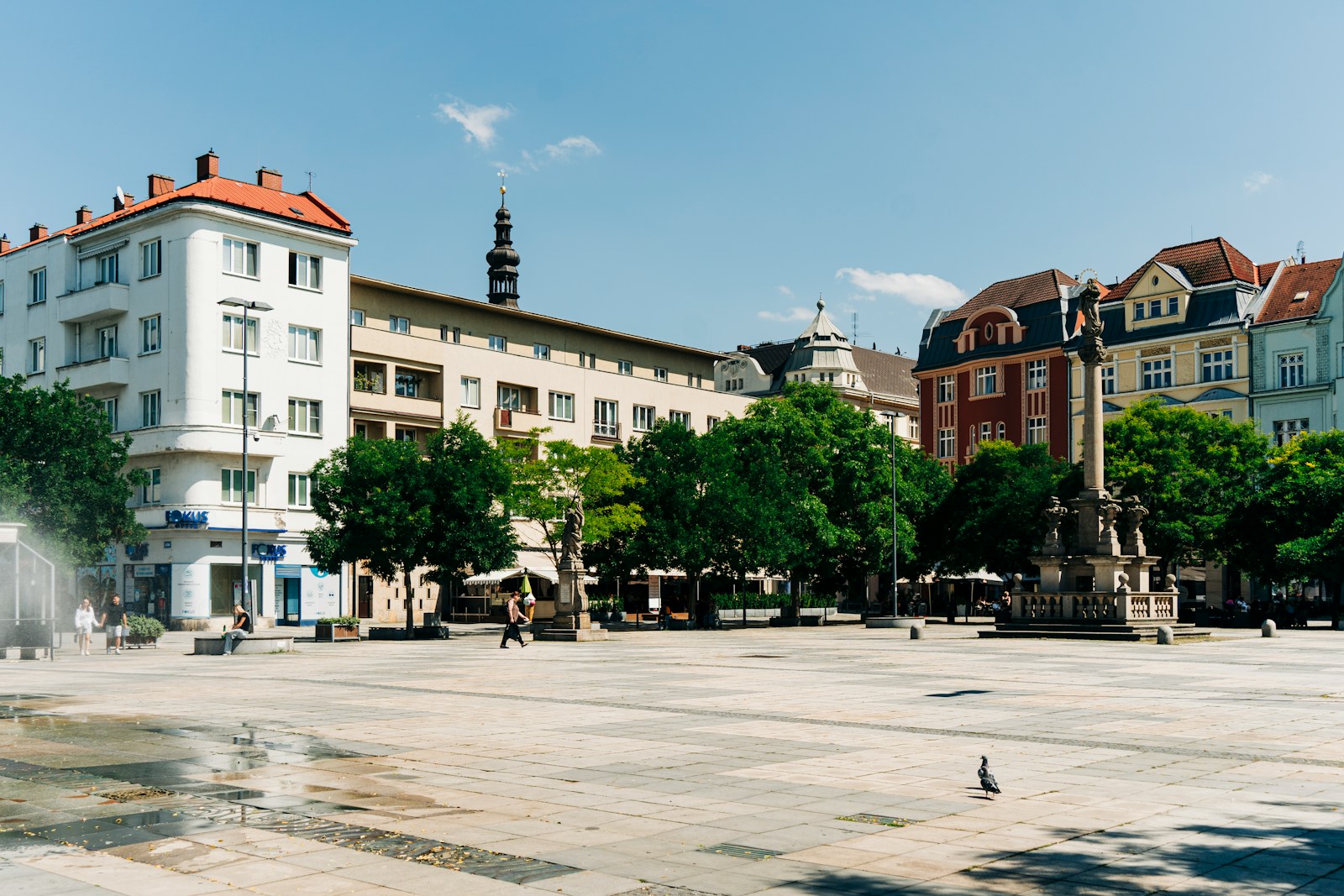 a city square with a fountain in the middle of it