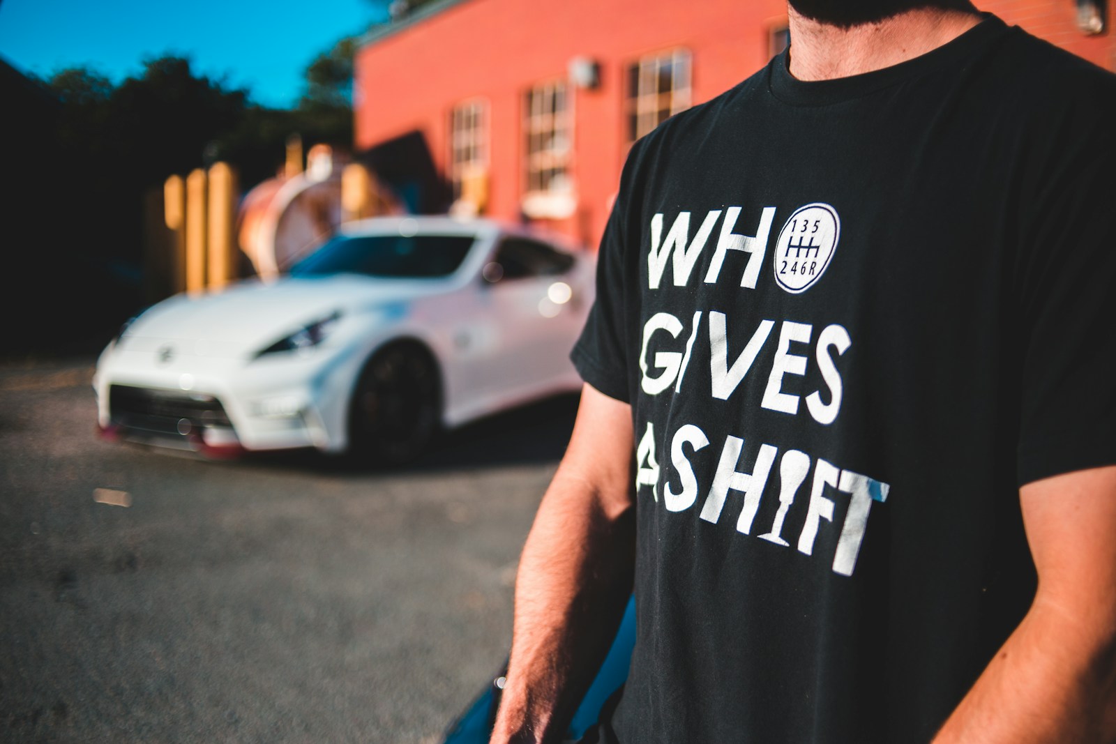 man in black crew neck t-shirt standing on road during daytime