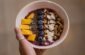 person holding bowl with food