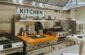 a kitchen with stainless steel appliances and a wooden counter