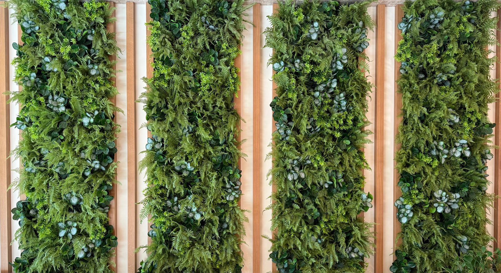 Four vertical panels of lush green plants.